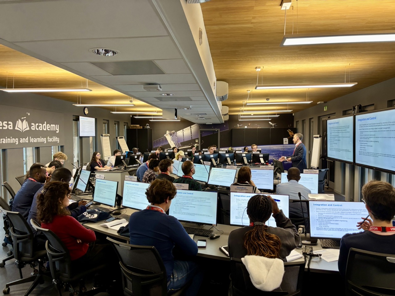 image of engineers working on satellite components [team]