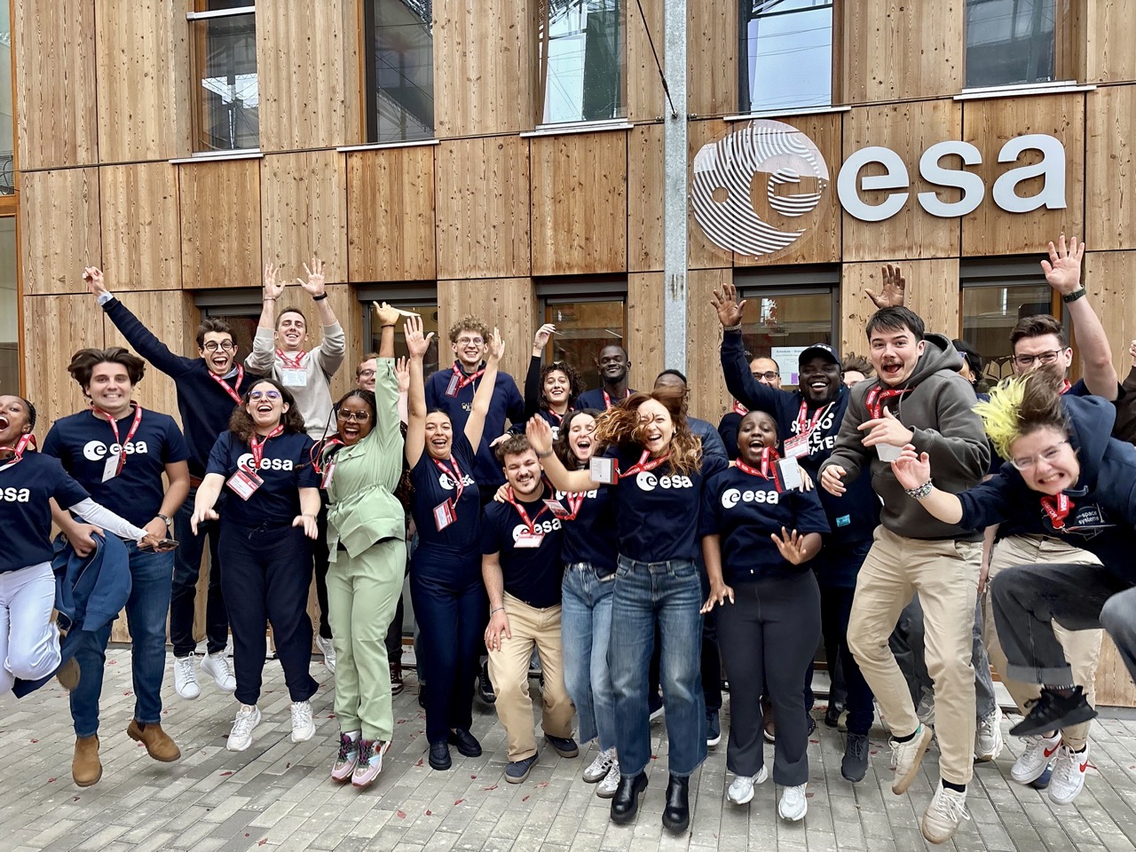 image of engineers working on satellite components [team]