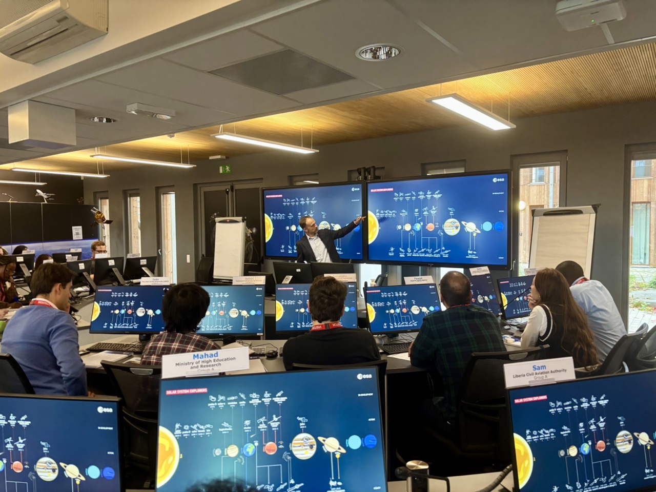 image of engineers working on satellite components [team]