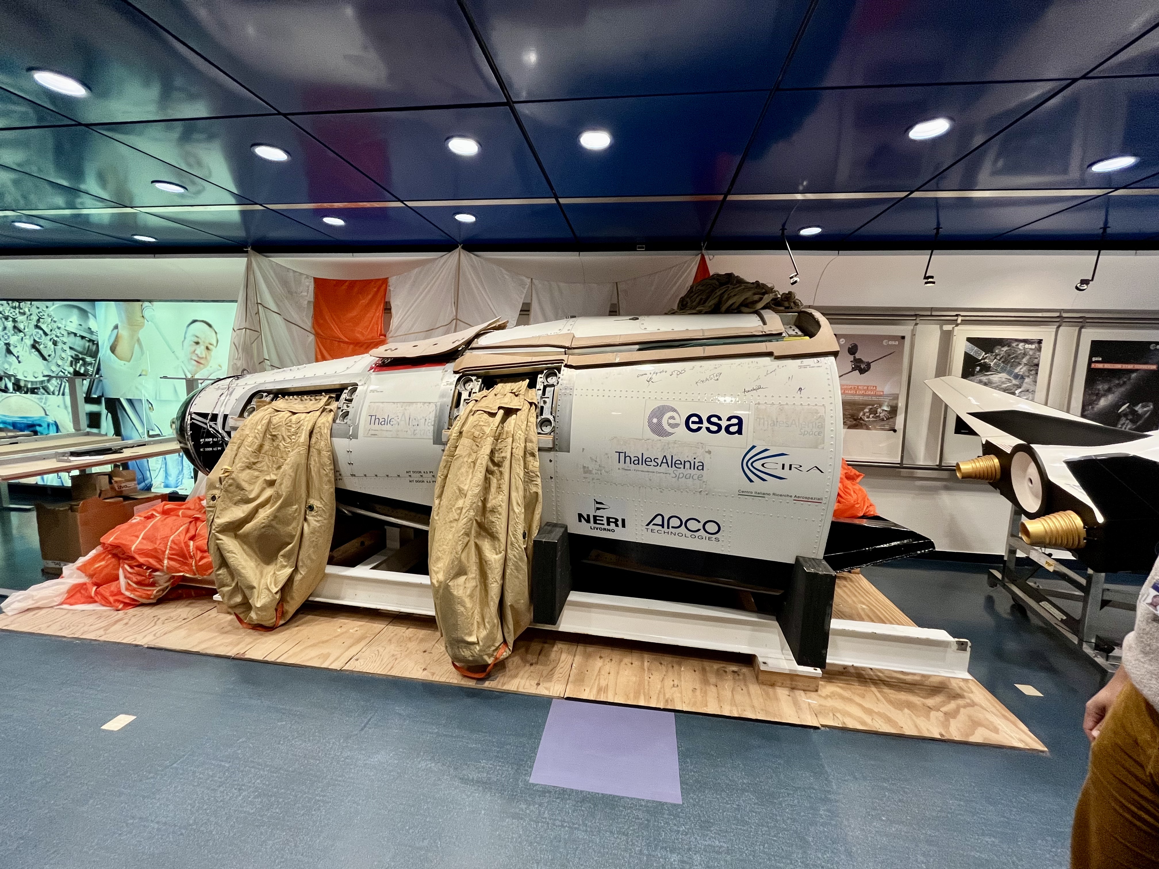 image of engineers working on satellite components [team]