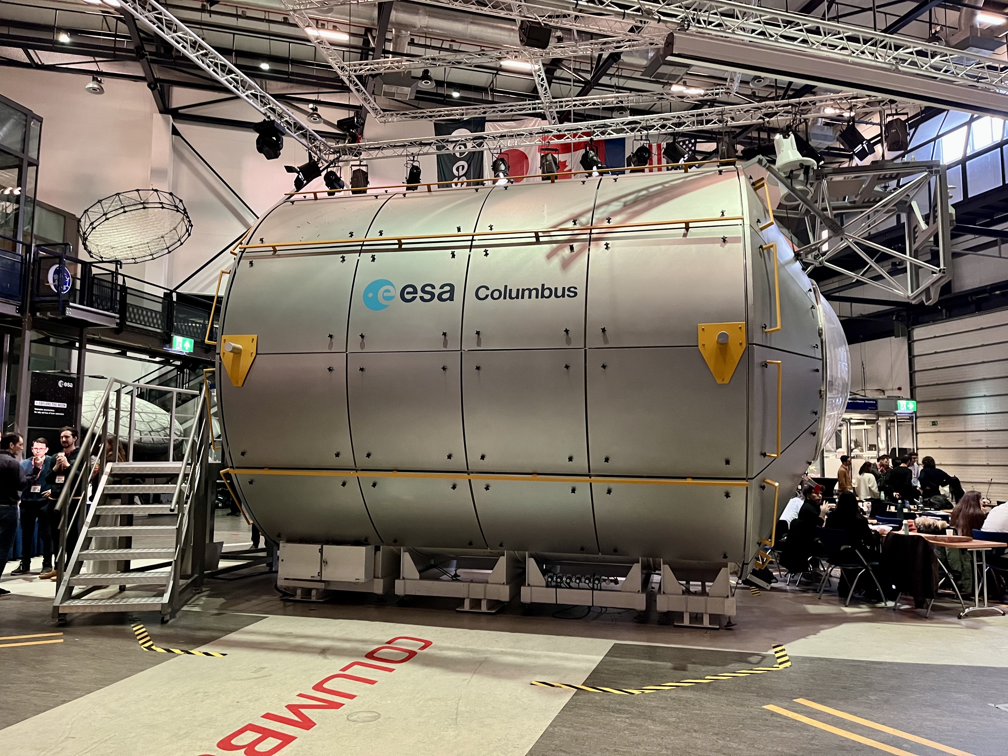 image of engineers working on satellite components [team]