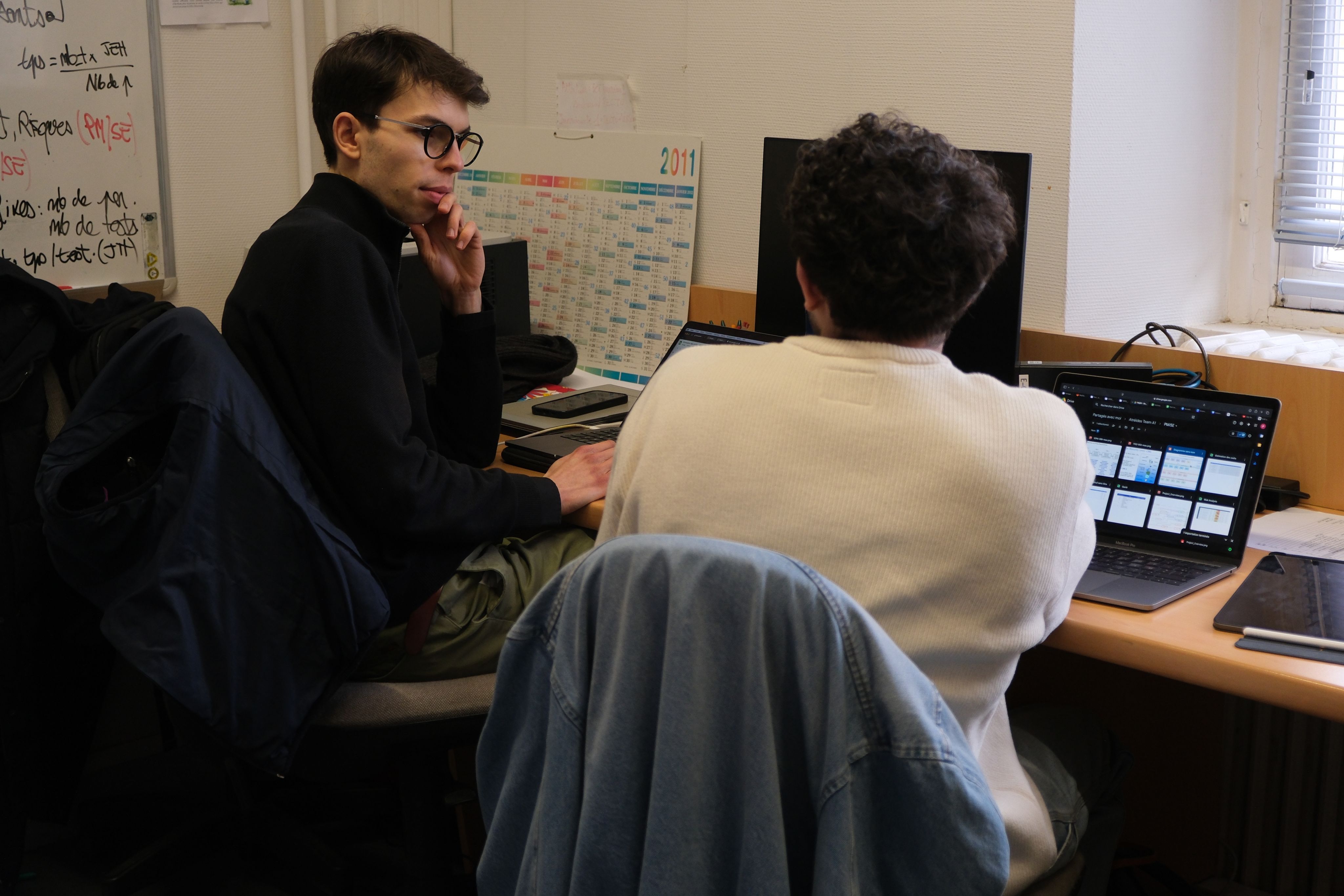 image of engineers working on satellite components [team]