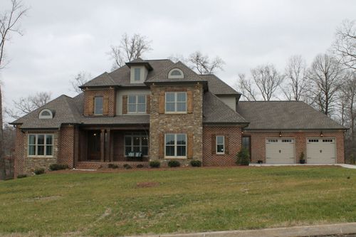 A stately custom residence that artfully combines traditional brick and stone masonry with an expansive, light filled interior designed for grand-scale living.