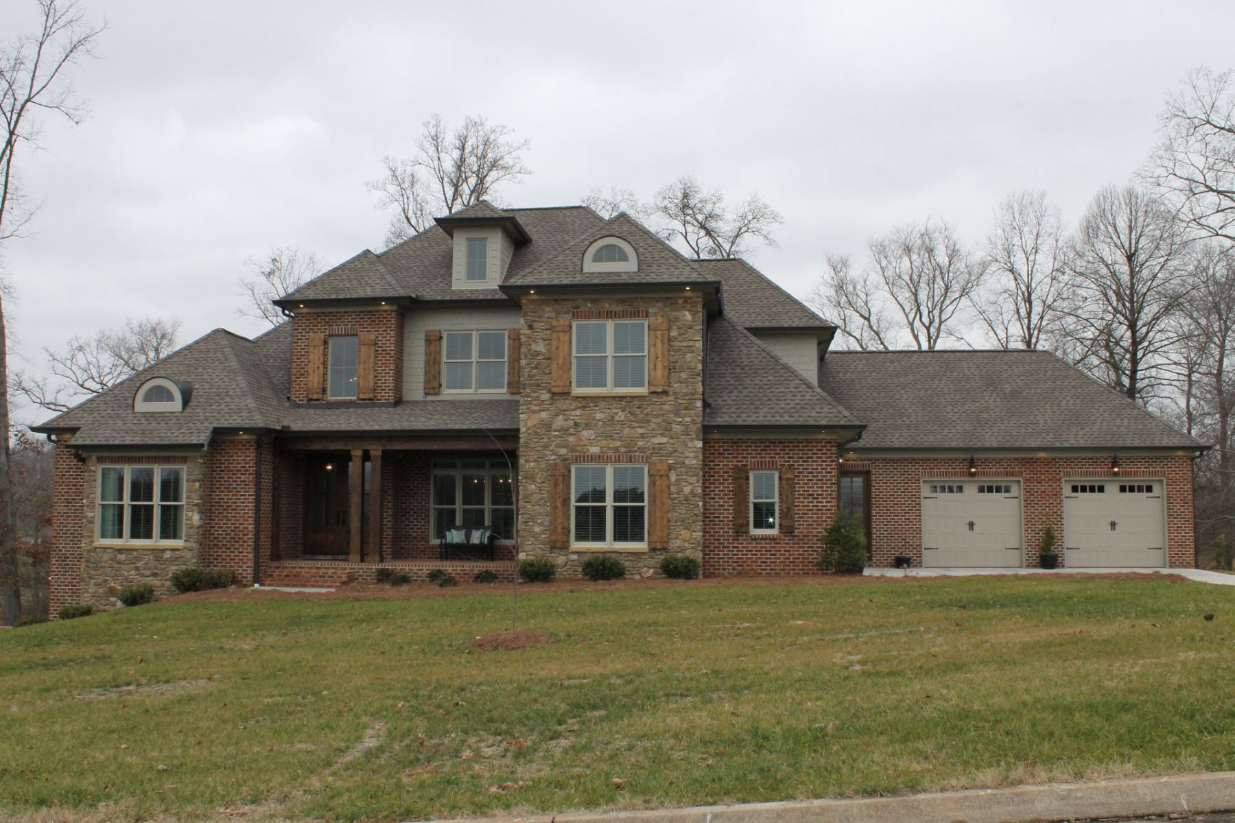 A stately custom residence that artfully combines traditional brick and stone masonry with an expansive, light filled interior designed for grand-scale living.
