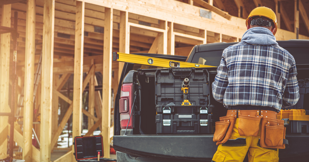 Construction-themed financial planning graphic featuring a yellow hard hat, blueprints, calculator, and a notebook labeled “Cash Flow Plan” beside the headline “The Cash Flow Problem That Most Contractors Miss.”