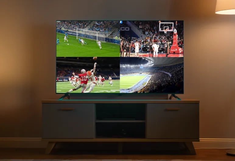 Television on a wooden stand displaying a split screen showing soccer, basketball, American football, and a stadium crowd.