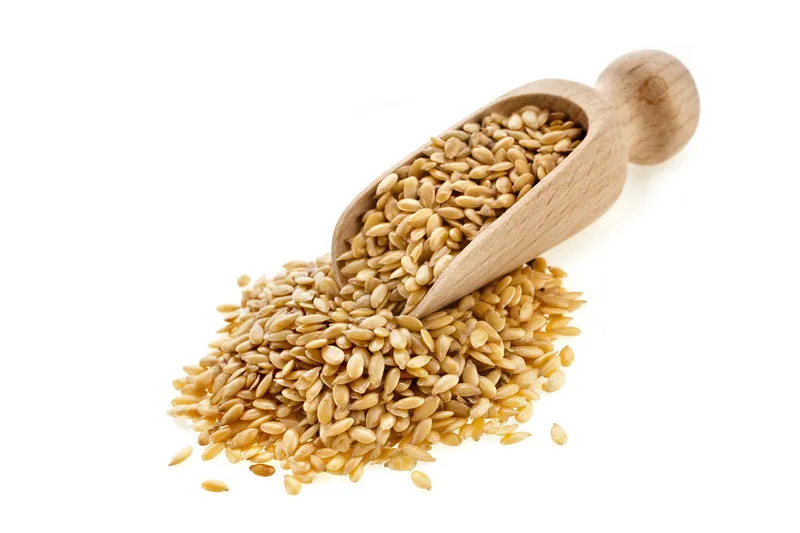 Golden linseed in a wooden scoop