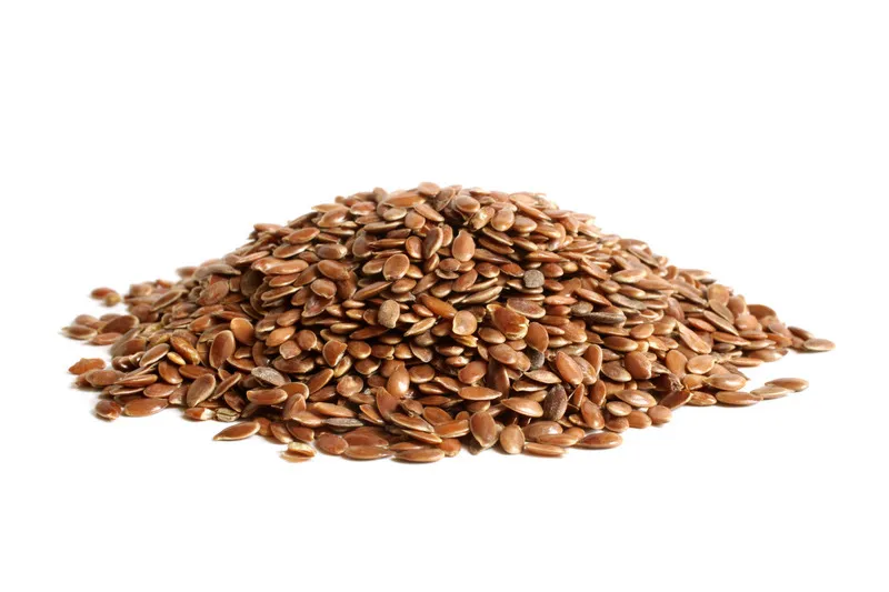 Pile of brown linseed on white background