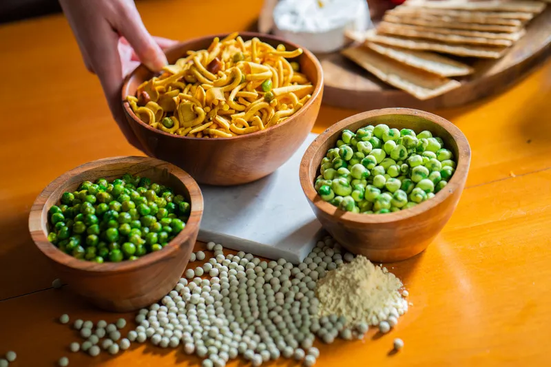 Wasabi peas, bhuja mix in wooden bowls