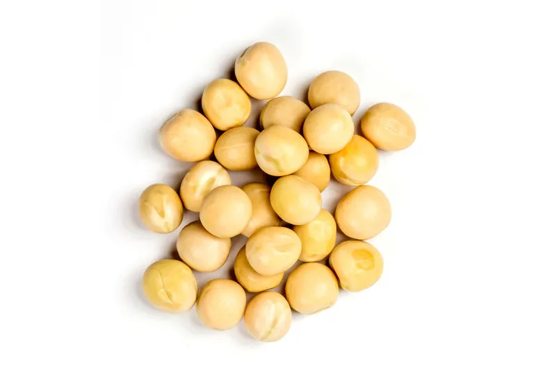White peas in a pile on white background