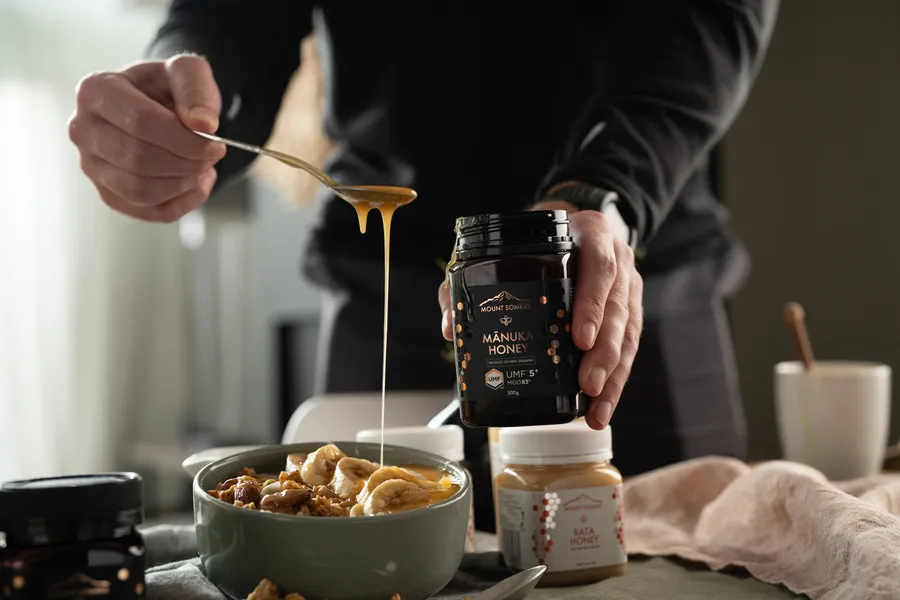 Man pouring Mount Somers Manuka honey on breakfast cereal