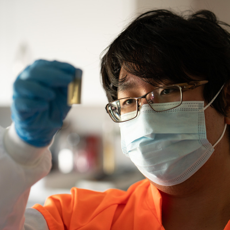 Honey technician inspecting honey in test tube