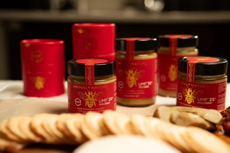 A range of Primal By Nature jars with cheese and crackers in the foreground