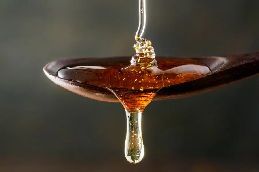 Kamahi honey on a wooden spoon