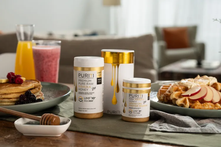 Puriti Manuka Honey UMF 10+ and UMF 31+ on a table with pancakes and waffles