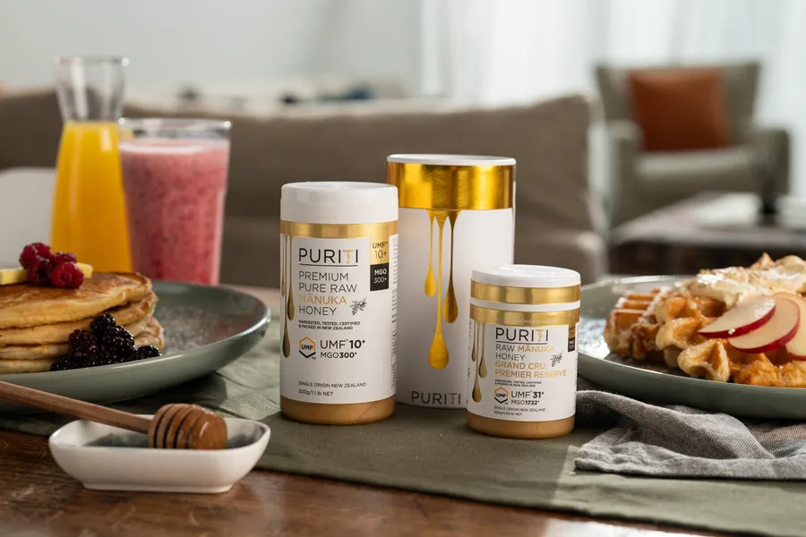 Puriti Manuka Honey UMF 10+ and UMF 31+ on a table with pancakes and waffles