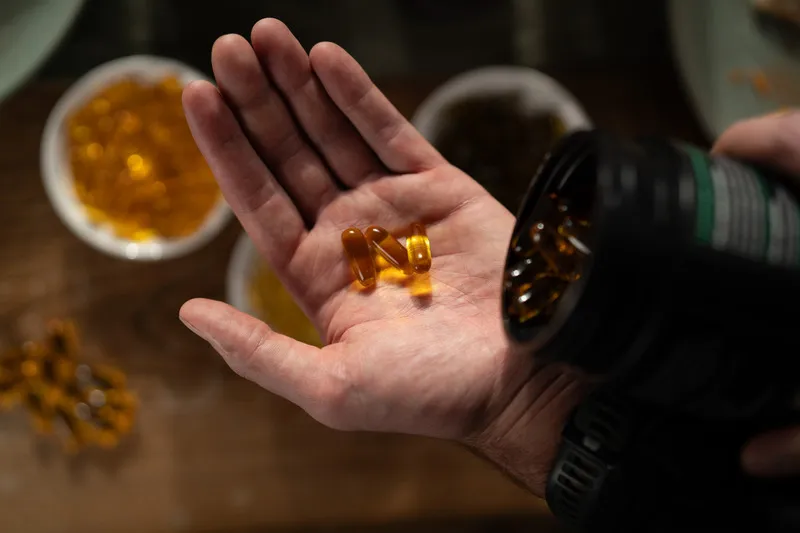 OmegaNZ capsules being poured into hand