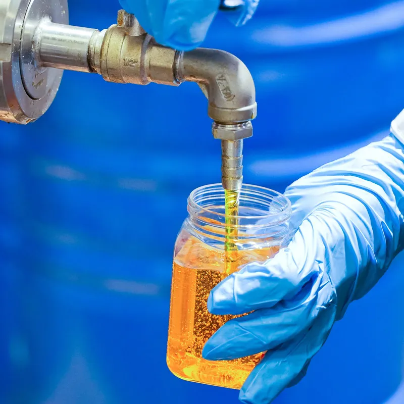 Golden oil being sampled for testing