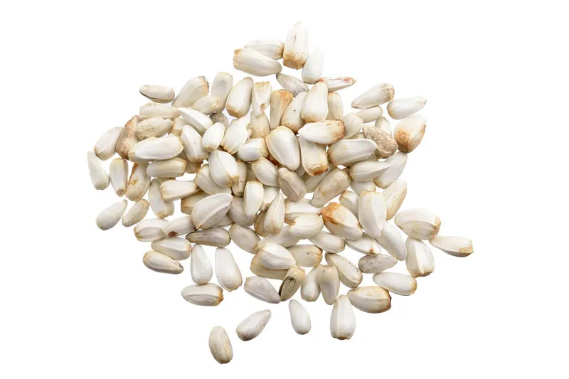 Safflower seeds in a pile on a white background