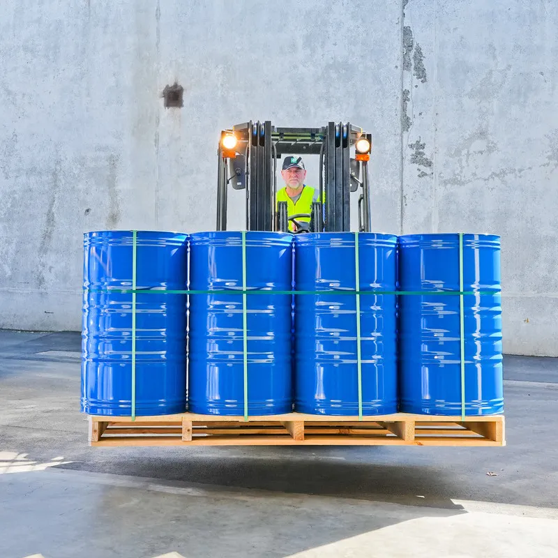 Rosehip oil in blue bulk drums being moved with a forklift