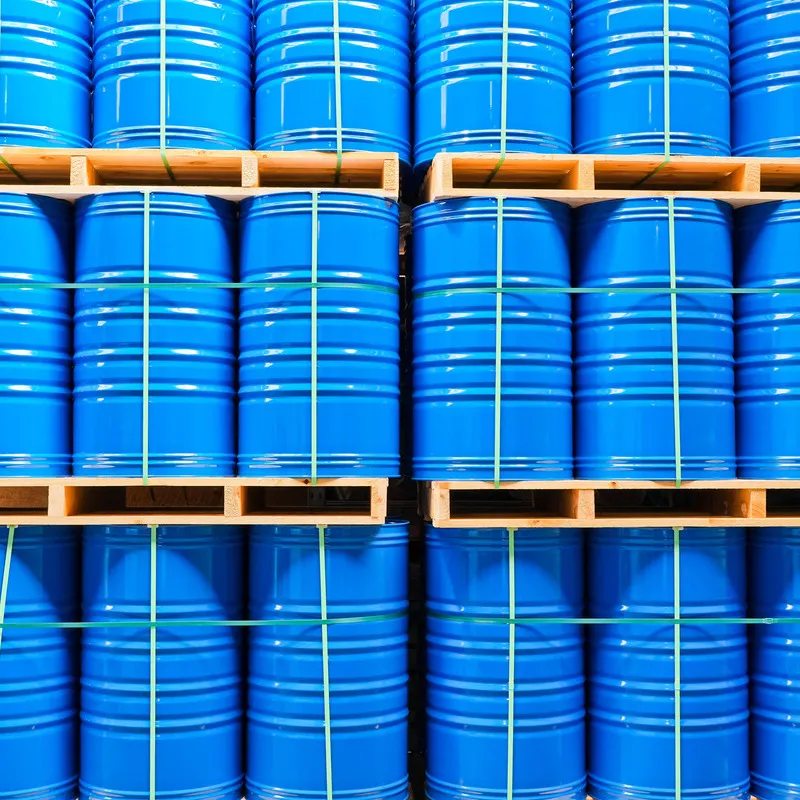 Blue bulk drums of oil stacked three high on pallets