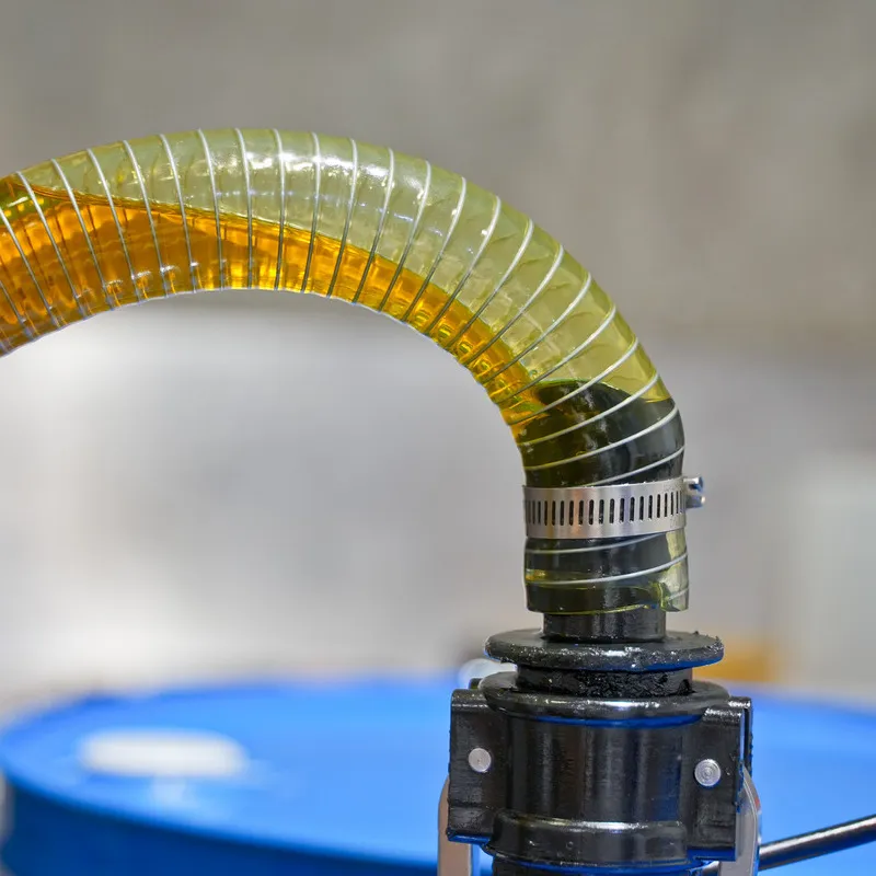 Blackcurrant oil being pumped into a blue bulk drum