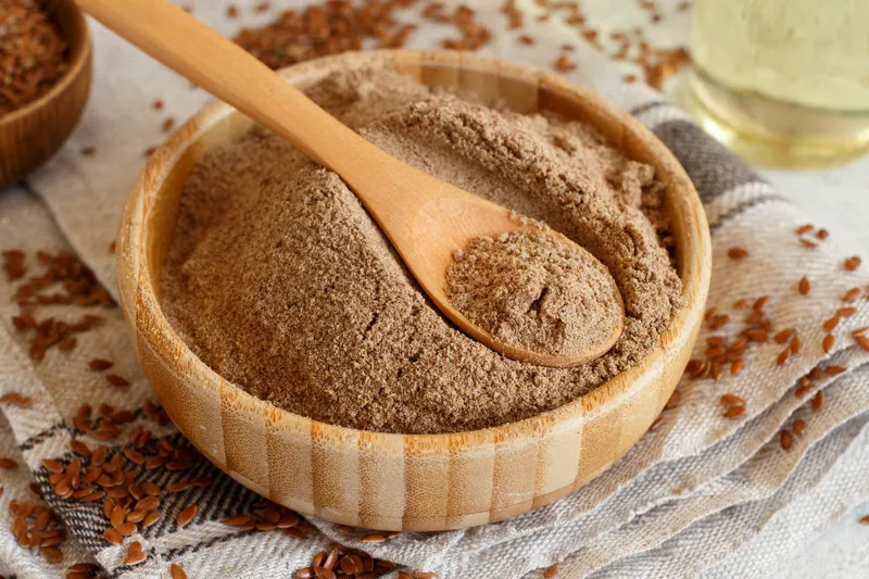 Close up flaxseed fibre in wooden bowl with wooden spoon