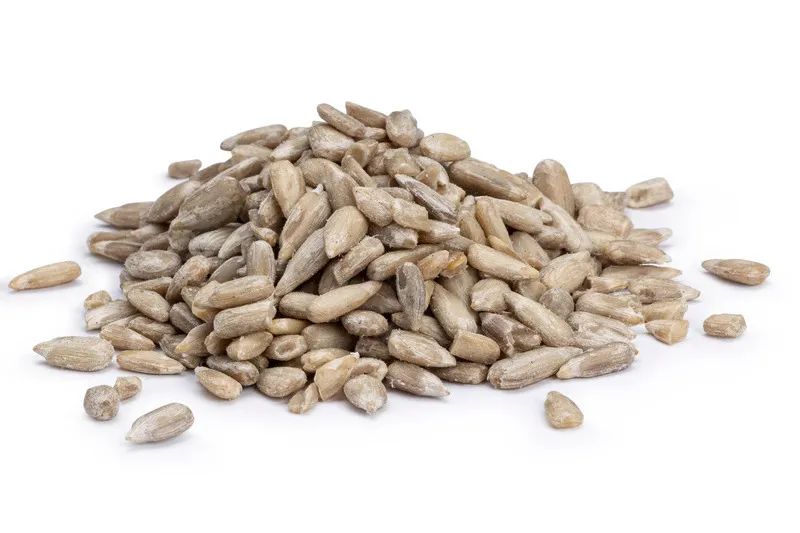 Pile of sunflower seeds on white background