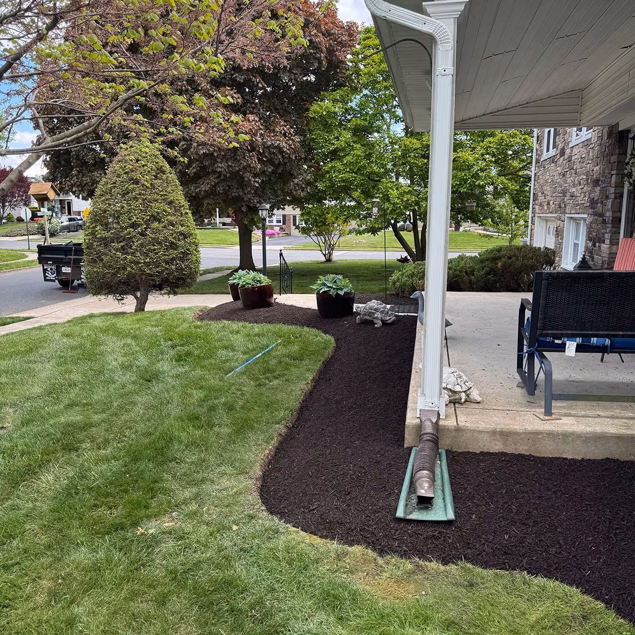 Fresh mulch installation by Morrisroe Landscaping for clean, professionally maintained landscape beds near me