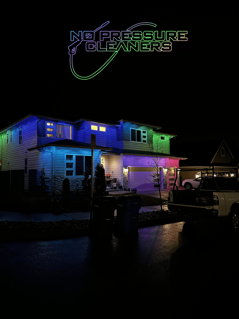 Two-story house lit at night with colorful permanent exterior LED lighting