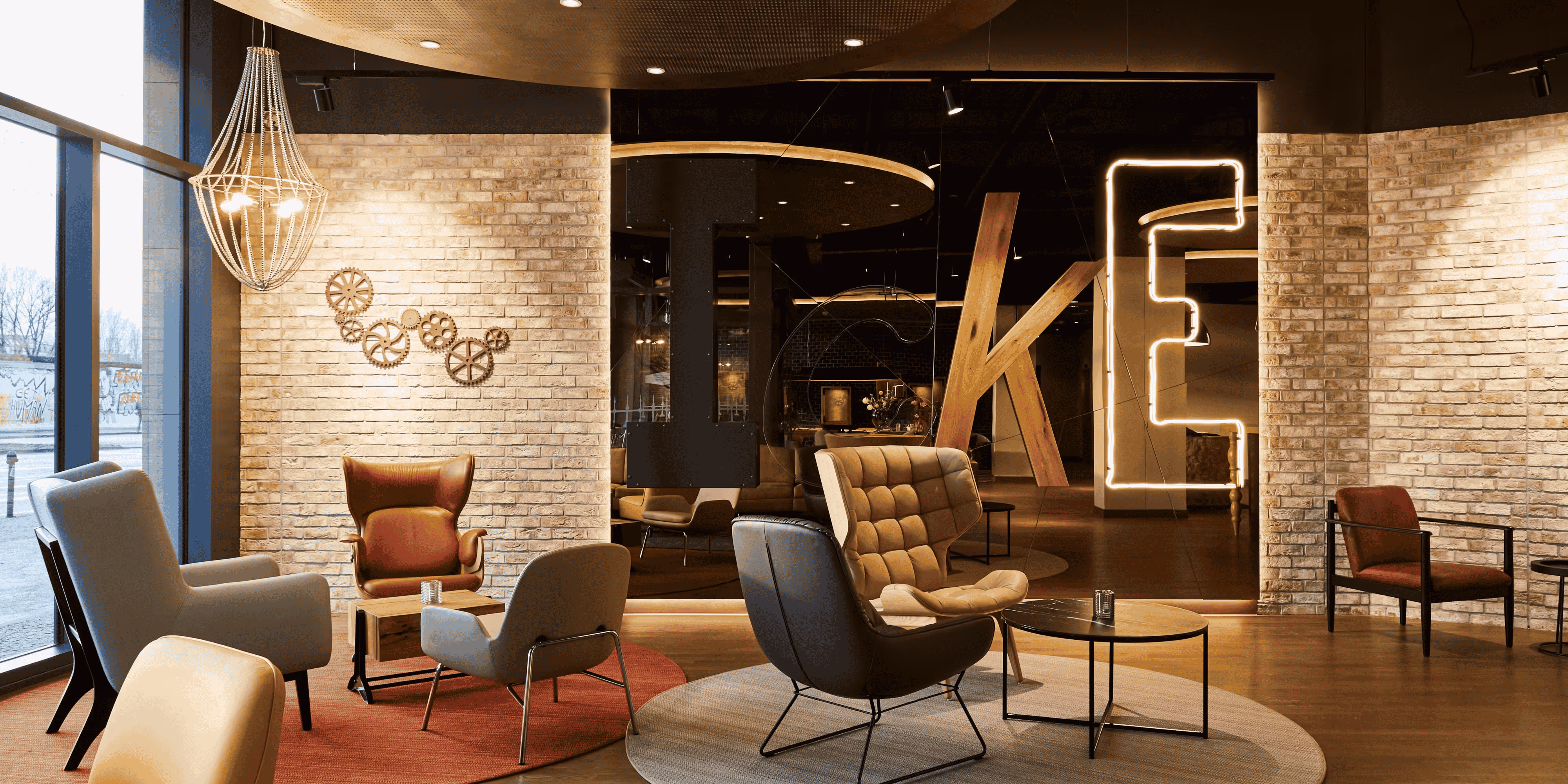 Stylish lounge area with brick walls, chairs, and modern decor.