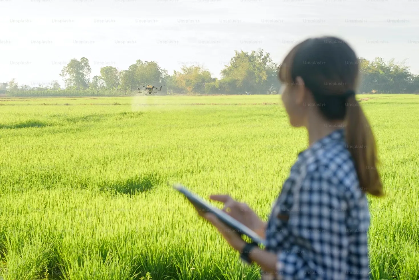 A farmer using a drone.