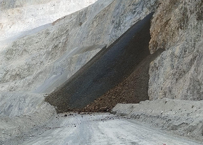 Road ramp on mine site blocked off with blast debris