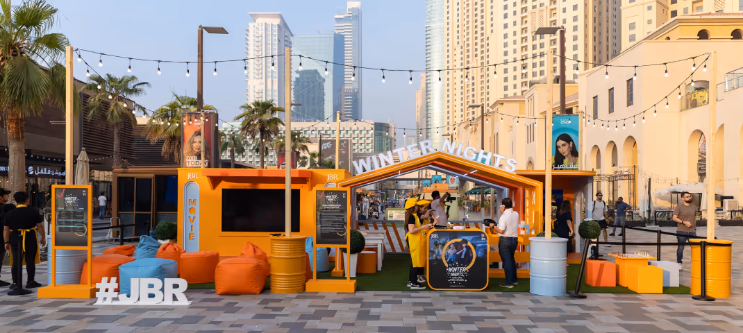 Latte with ornate rosetta art in a rugged, stone-like cup on a marble base.