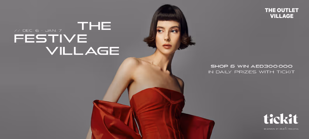 A fashion advertisement for "The Festive Village" featuring a woman in a red dress.
