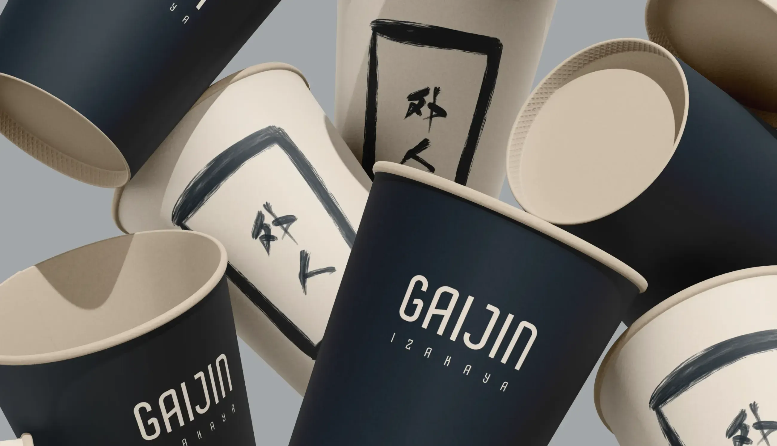 Branded paper cups with Gaijin Izakaya logo.