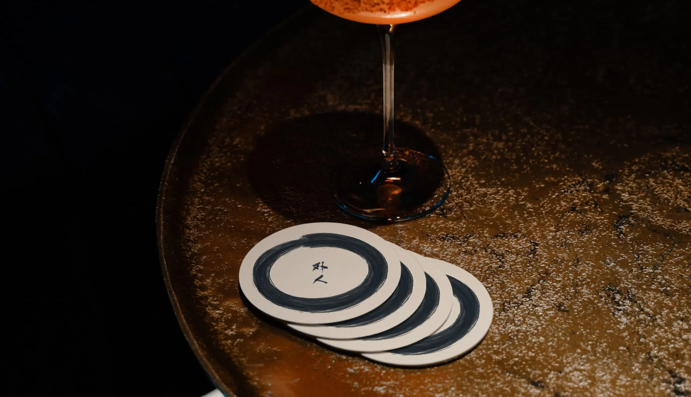 Branded coasters with Gaijin Izakaya logo design.