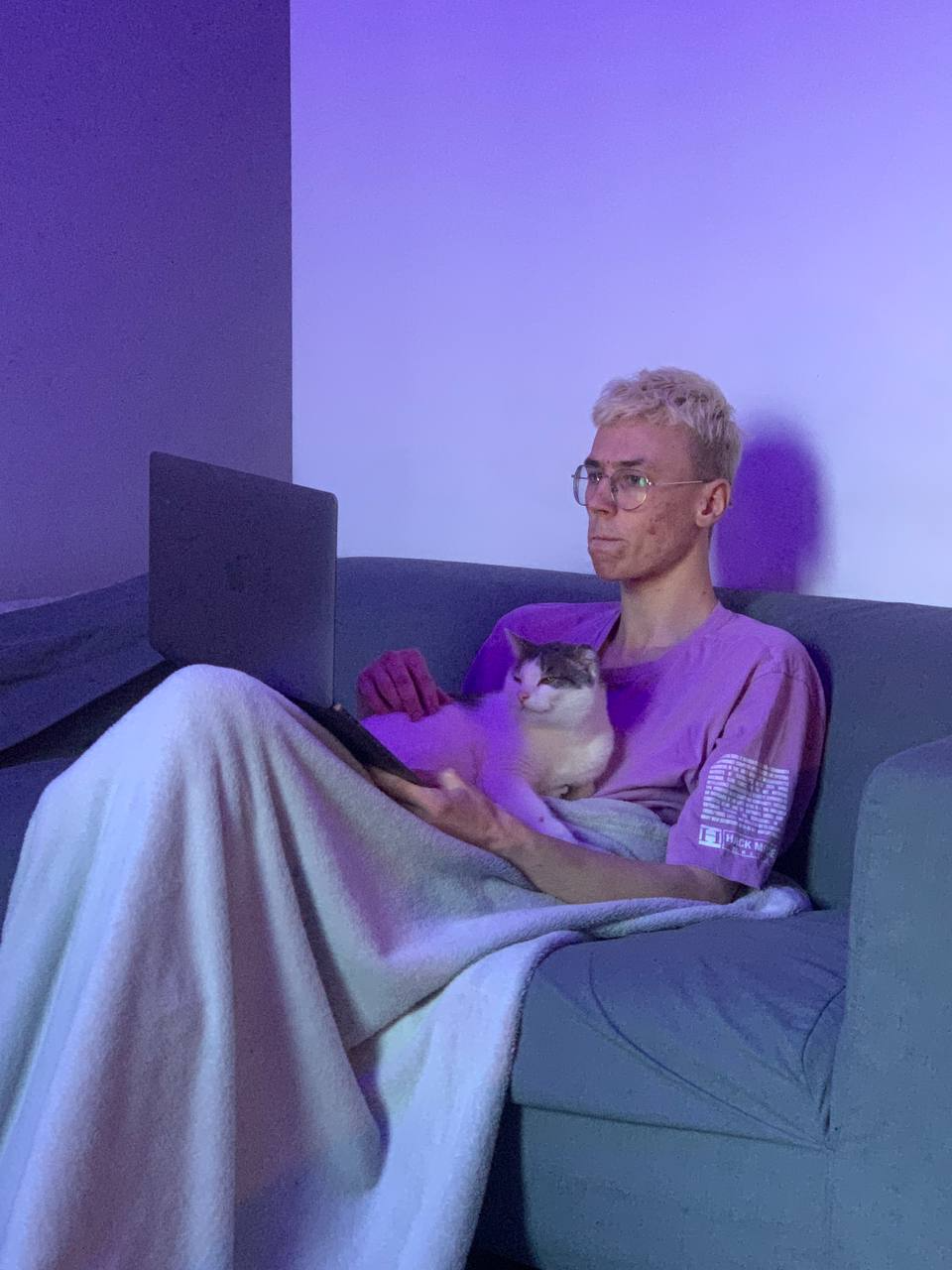 Roman Burachevsky working on laptop, focused on design project.