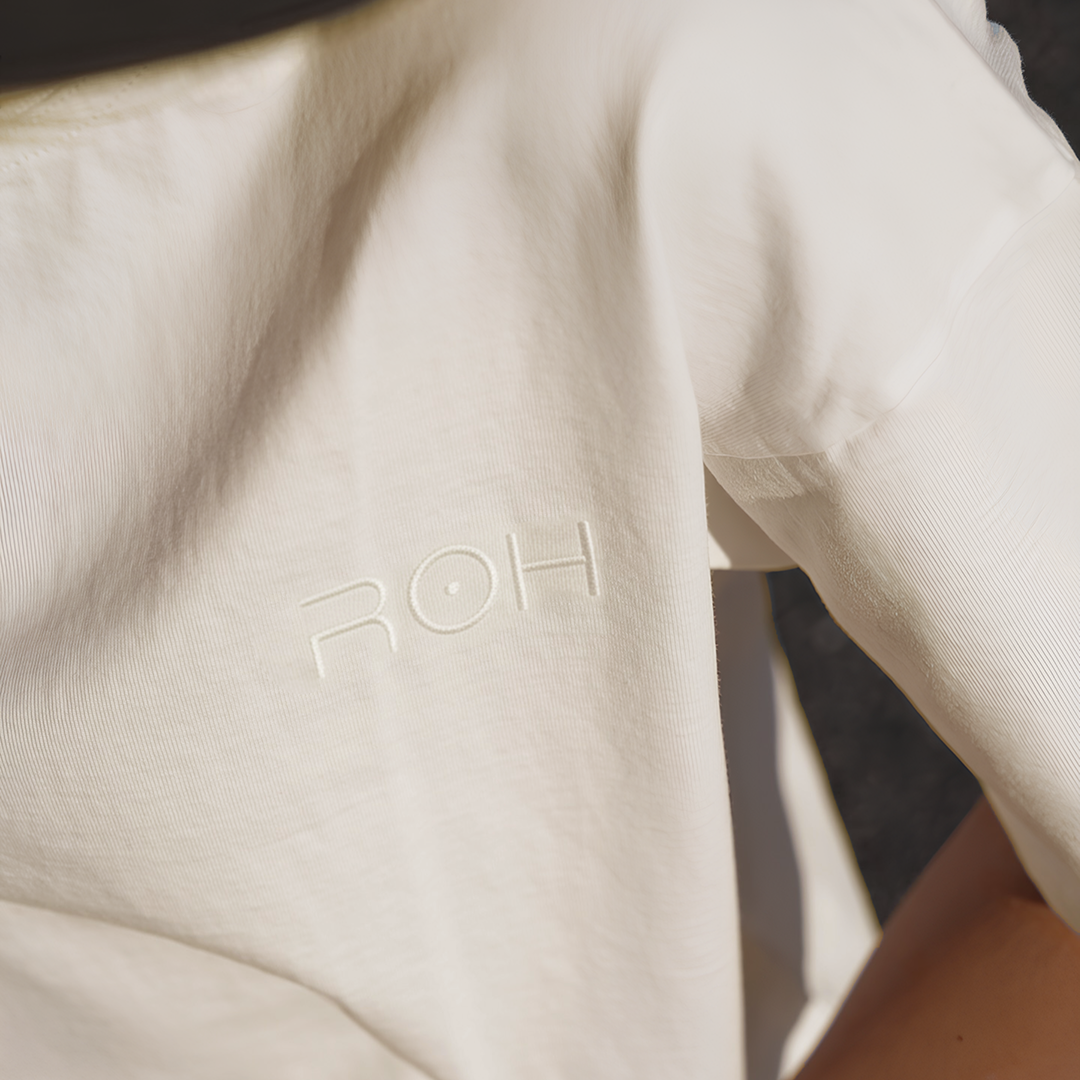Close-up of a cream-colored fabric with the embossed 'ROH' logotype.
