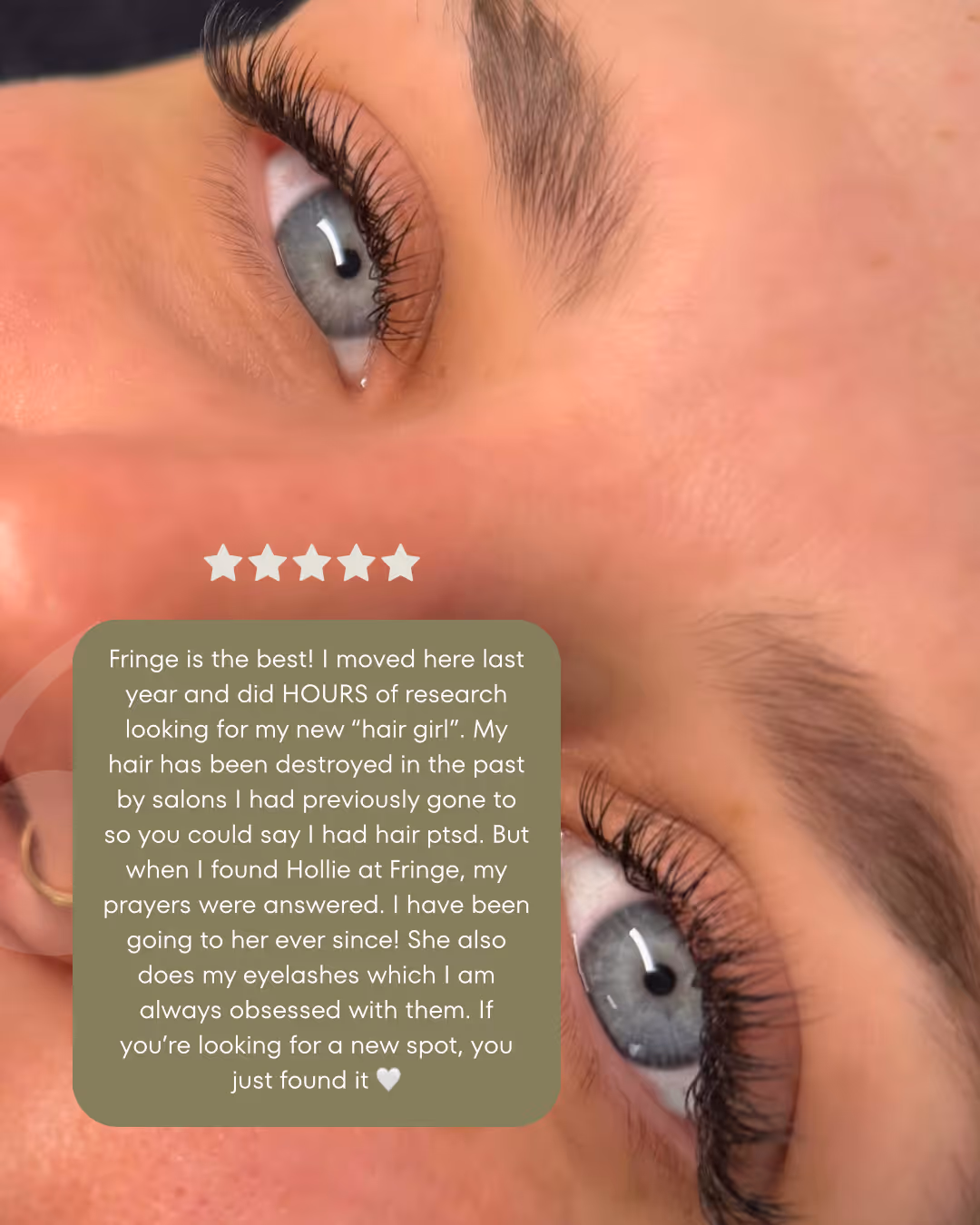 Close-up of a person's blue eyes with long eyelashes and well-groomed eyebrows.