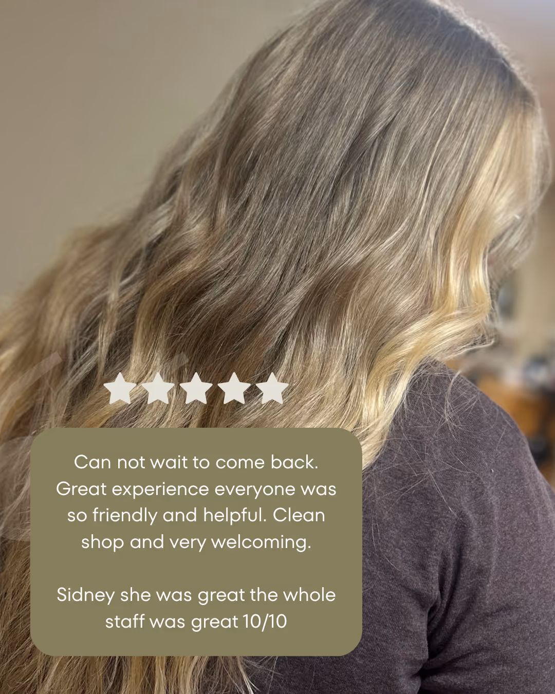 Back view of a woman with long, wavy blonde hair wearing a dark top and an overlaid customer review with five-star rating.