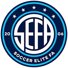 Blue and black circular Soccer Elite FA logo with year 2006 inside two rings.