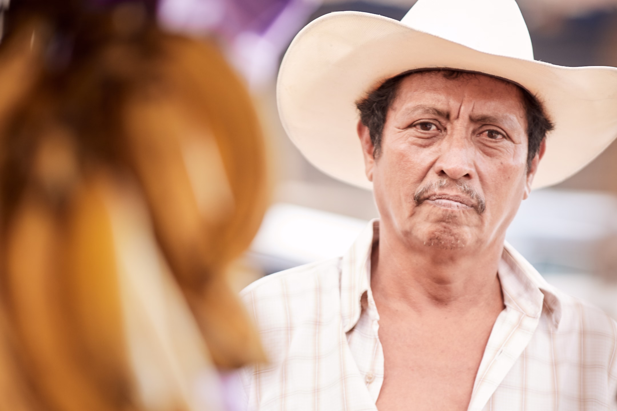 Closeup of man wearing a cowboy hat in Peten, Guatemala marketplace