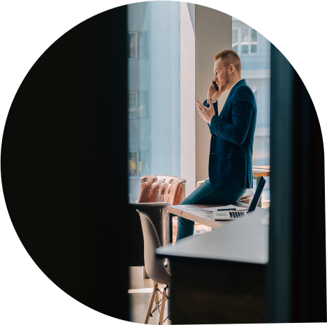 Professional on a phone call by an office window