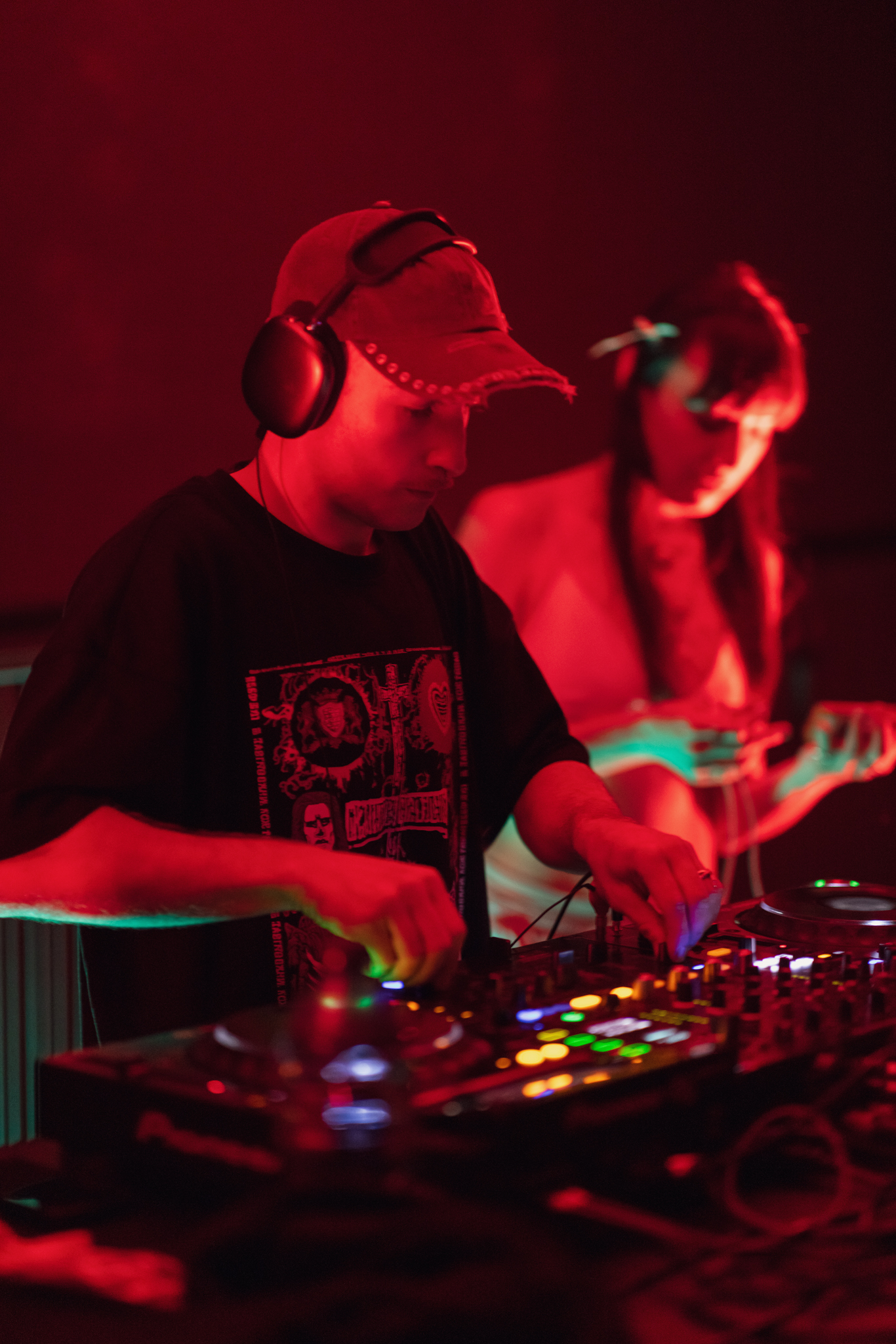 Positive young multiracial friends eating fast food and drinking beer in outdoor cafe