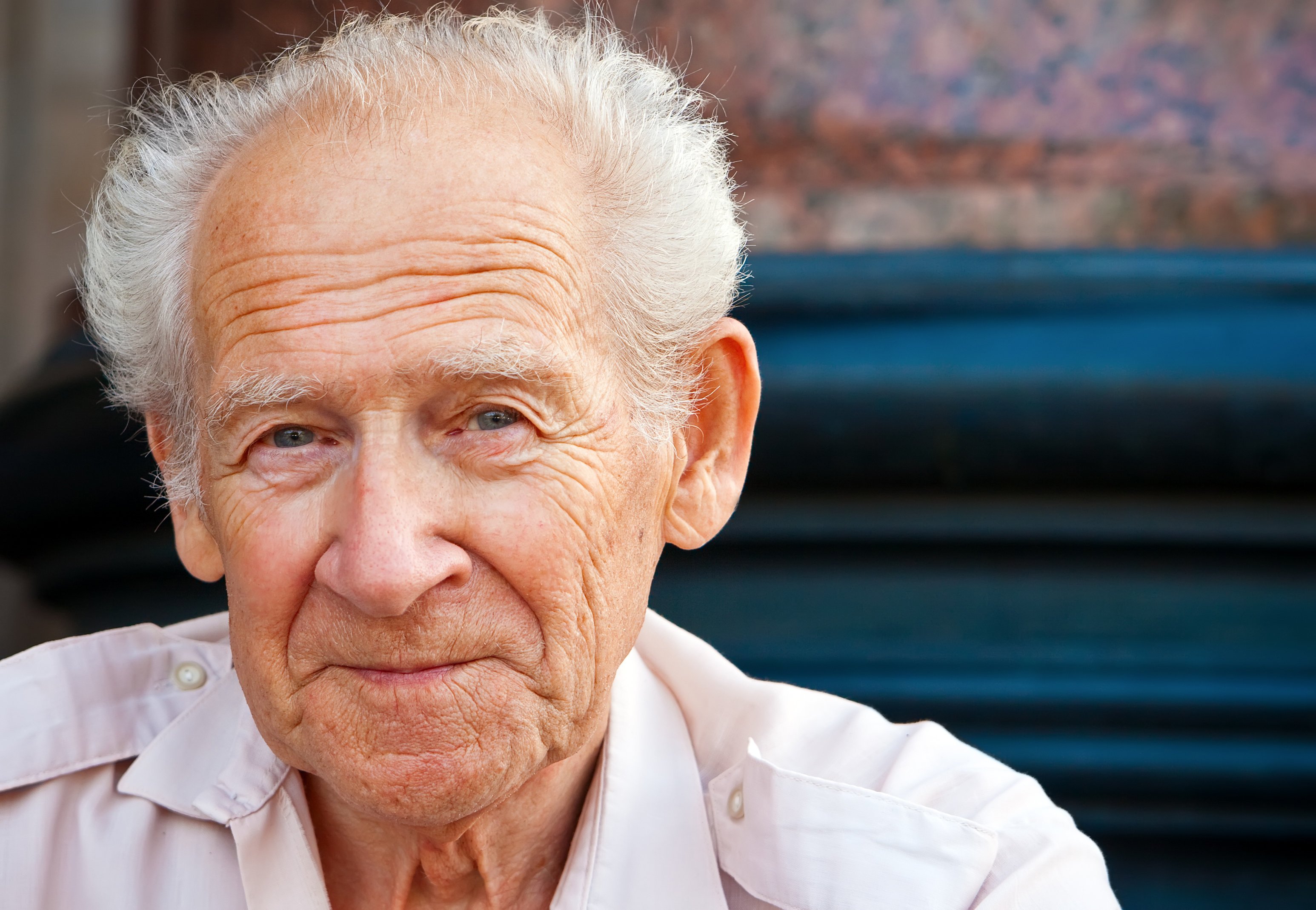 Elderly man smiling warmly, featured in the Legacy Tracks story