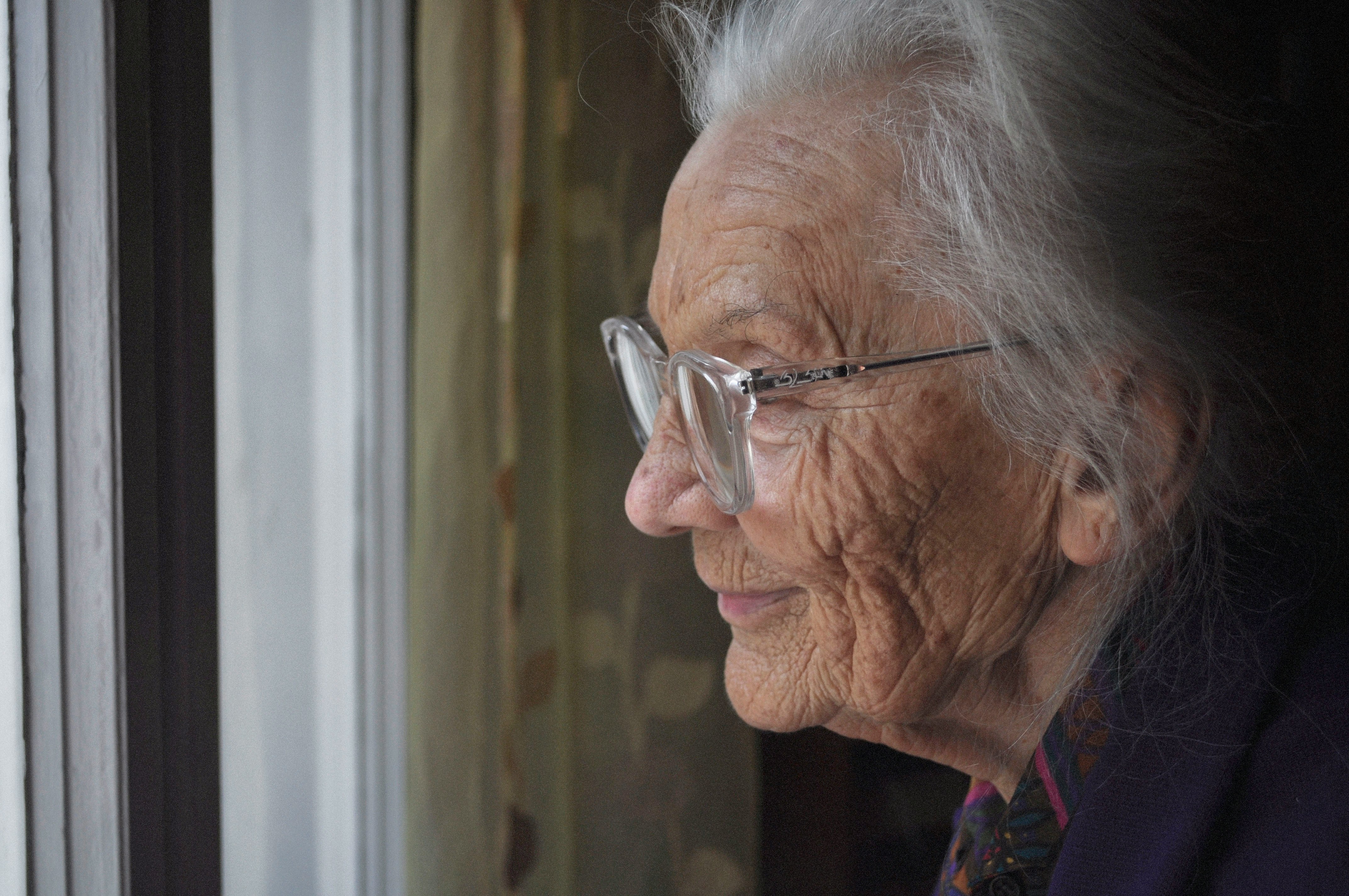 A grandmother smiling warmly, close up