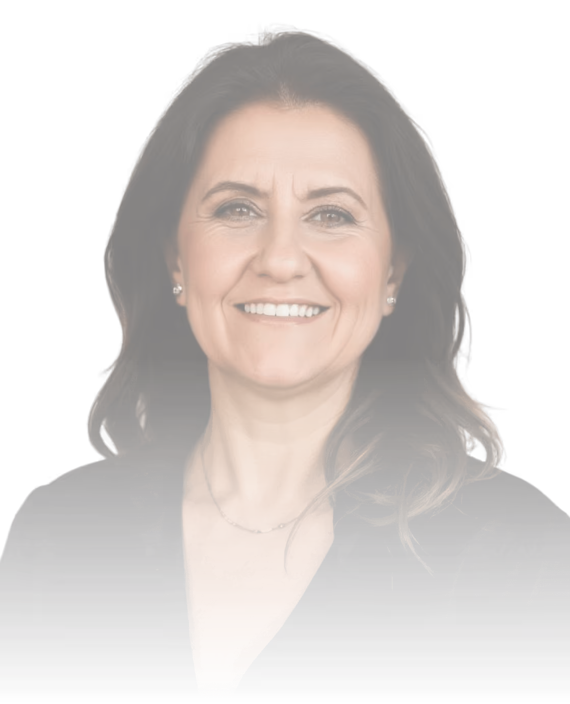 Frau mit dunklem Haar und schwarzer Kleidung lächelt vor neutralem Hintergrund.