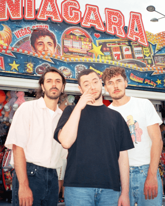 An analog photography of three musicians of the Blue Boys Club Band took in a funfair in France