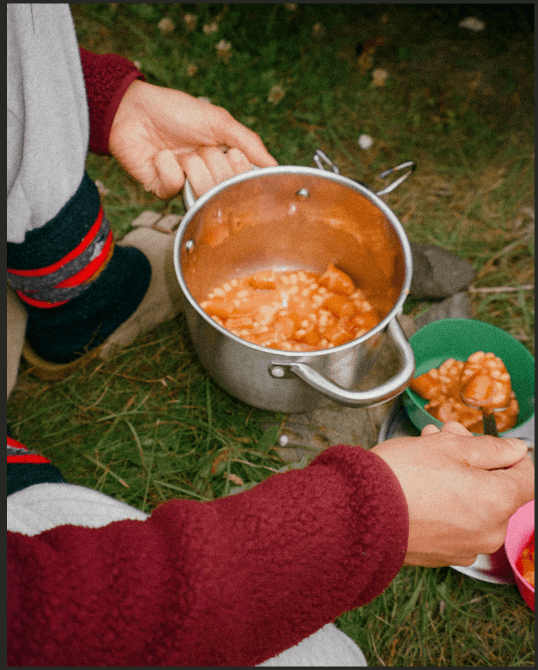 An analog photography of someone cooking in the nature took in Iceland